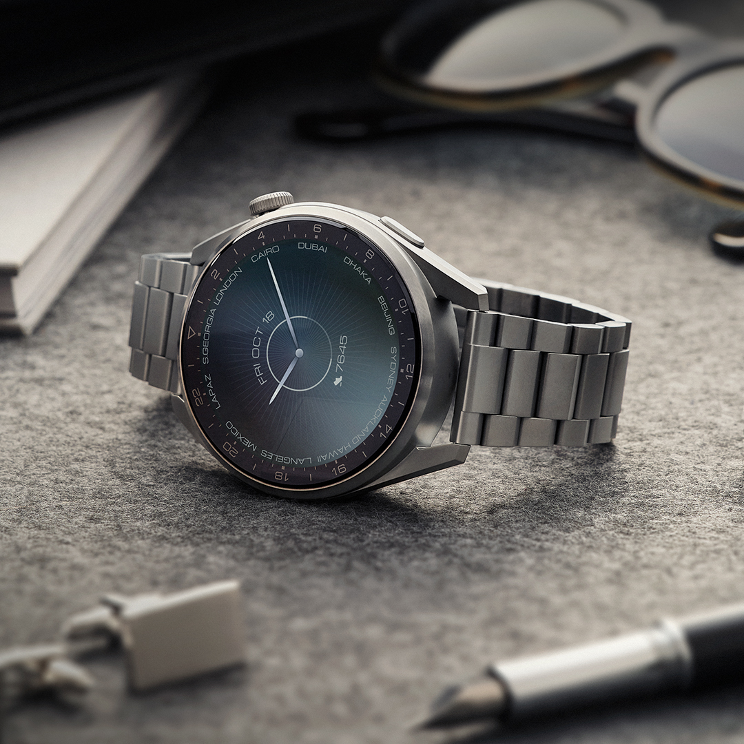 Metal smartwatch lying on desk