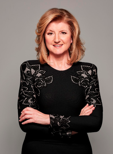 Arianna Huffington in black dress with arms crossed and smiling