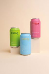 three cans of designer water HOUSEPLANT on a cream background