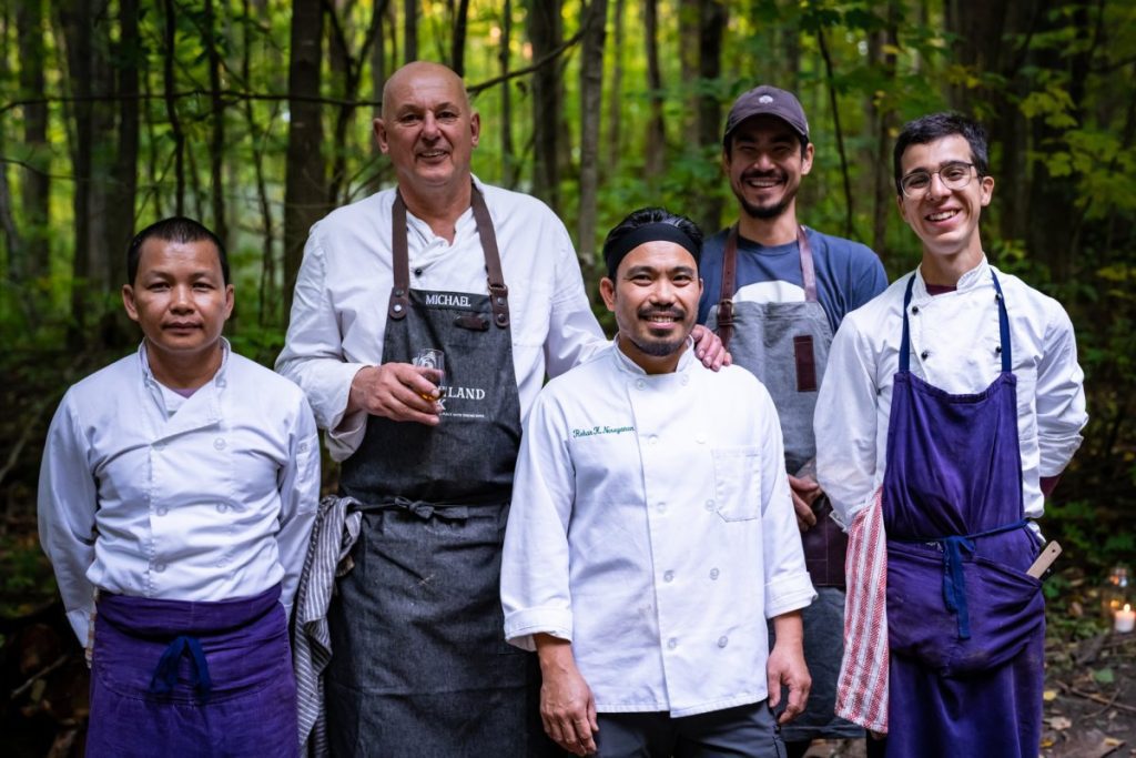 Chef Michael Statlander stands alongside his team at Eigensinn Farms.