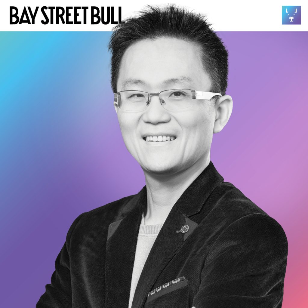 Wattpad ceo Allen Lau in blazer wearing glasses against gradient background