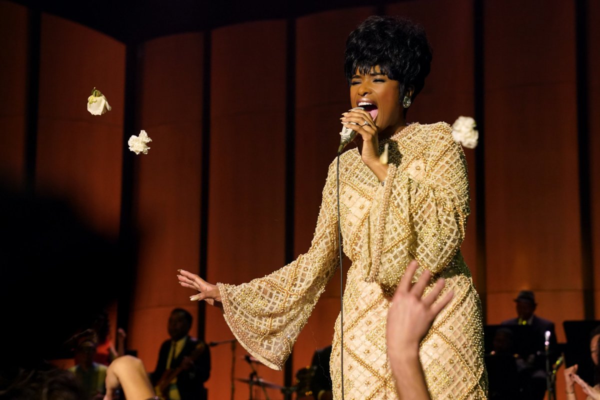 Jennifer Hudson in gold dress singing into a mic