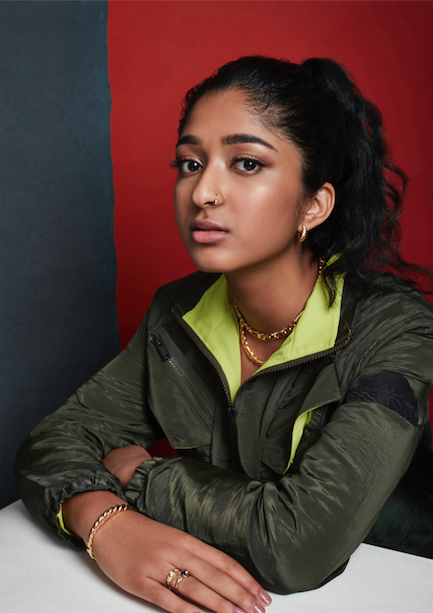 Actor Maitreyi Ramakrishnan in green jacket with arms crossed