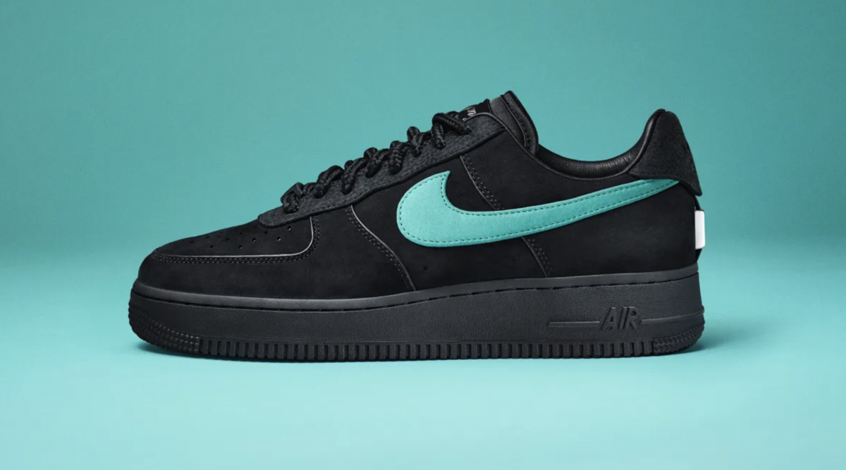 Black Nike sneaker with Tiffany blue swoosh on blue background.