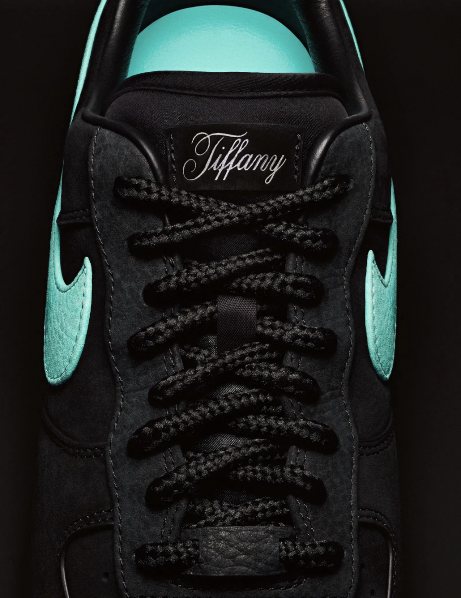 Black Nike sneaker with Tiffany branding on shoe tongue with blue swoosh