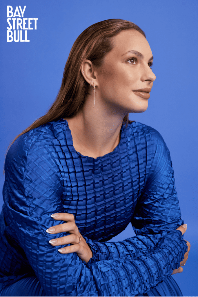 Penny Oleksiak in blue top against blue background