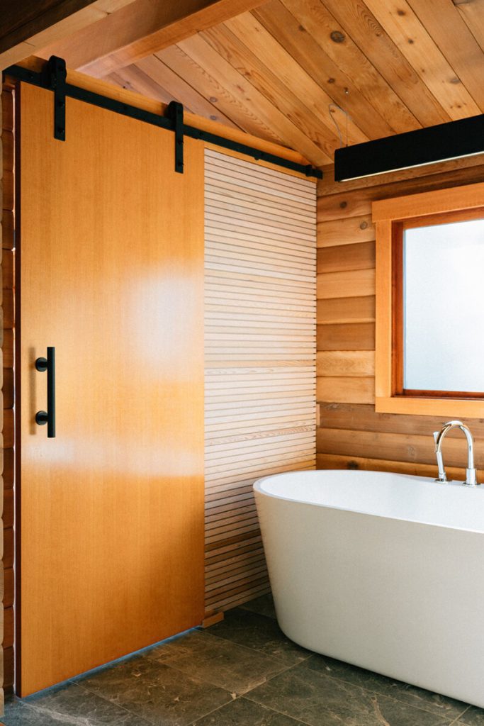Motel bathroom with wood accents and bathtub