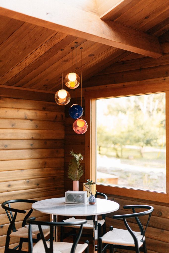 Motel dining room with wood accents and marble table with chairs