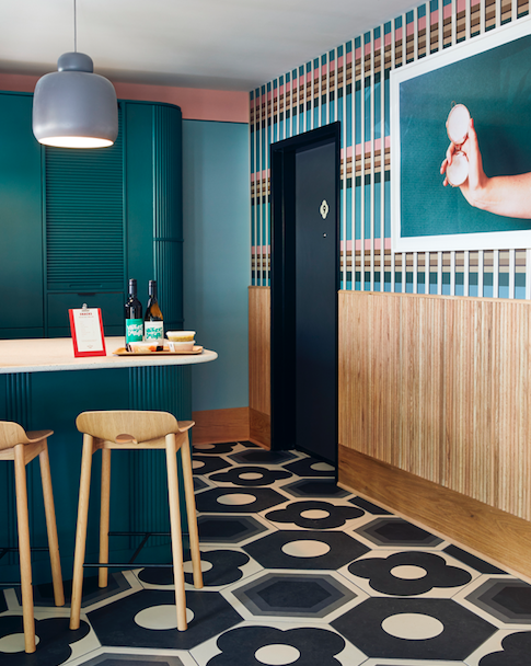 Motel kitchen with colourful accents and tiling