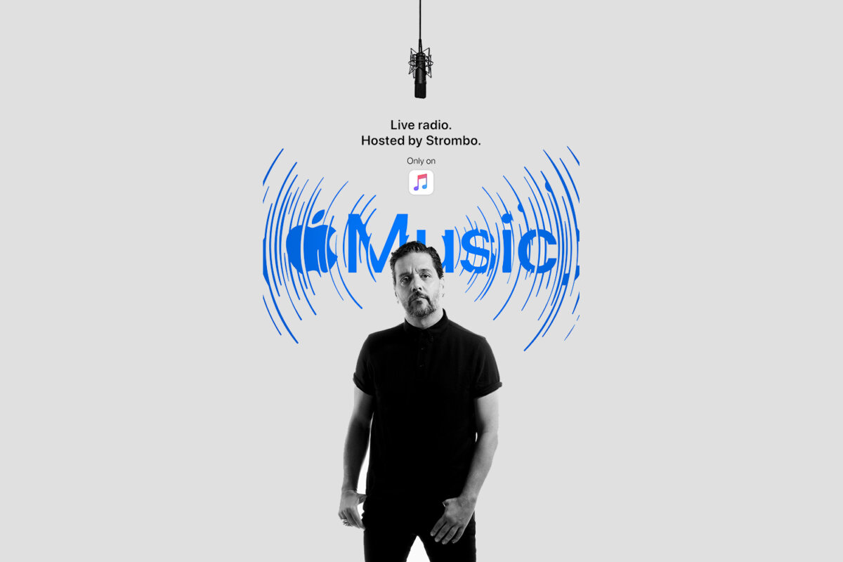 George Stroumboulopoulos with Apple Music logo behind him