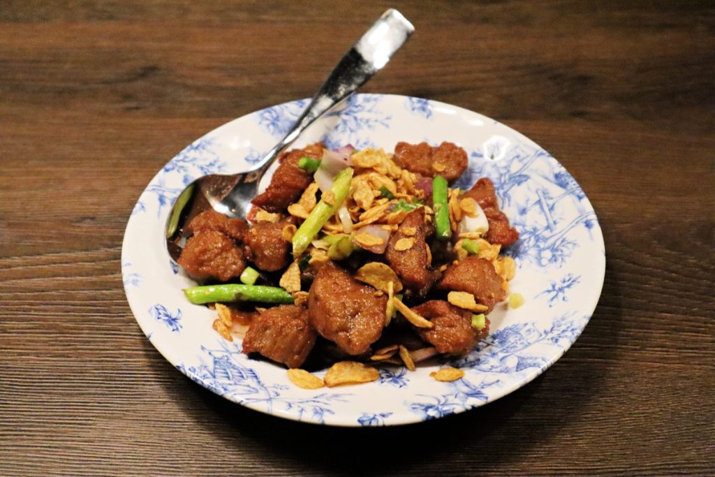 Hong Shing's garlic beef tenderloin, which is tossed in an umami-packed Maggi sauce and topped with fragrant golden garlic chips.