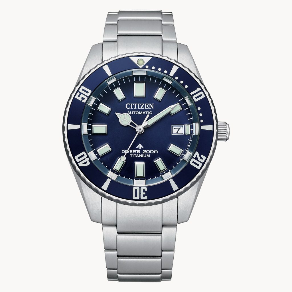 This photo shows the front face of the Citizen Promaster Dive Automatic watch. It has a sliver band with a sliver and blue case. The face of the watch is blue, and on the case it says "Citizen Automatic Diver's 200M Titanium".