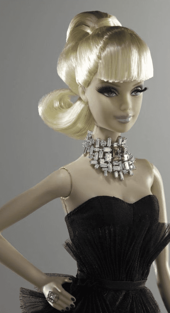 Barbie doll waring a diamond necklace and black dress.