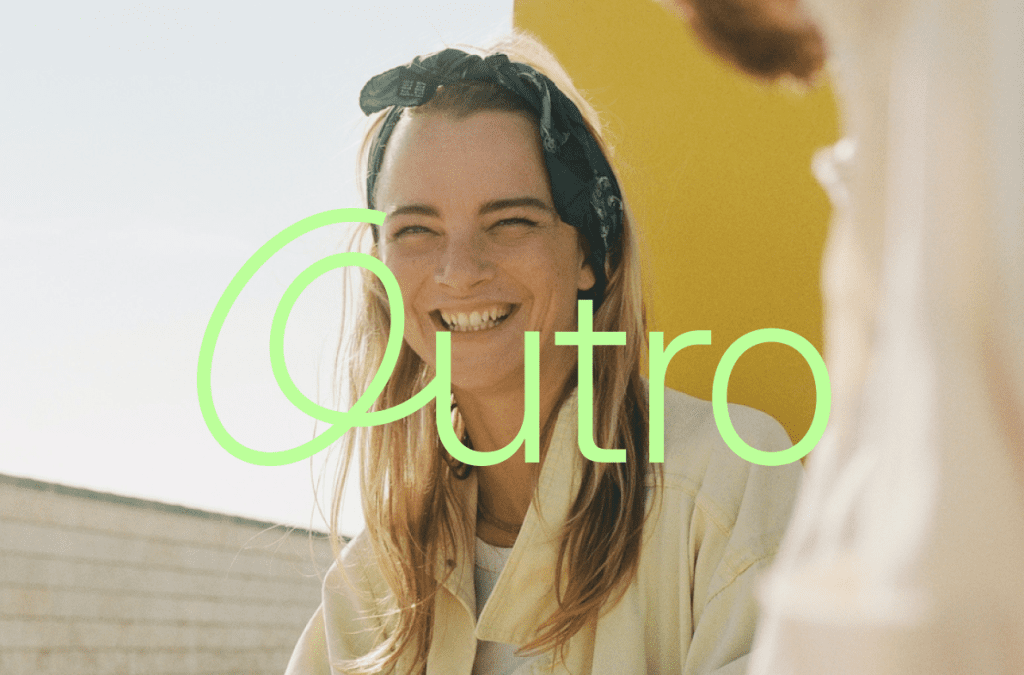 Photo of a young women smiling with a sunny background. She is wearing a green bandana tied around her head, and the Outro logo in green is superimposed over the image.