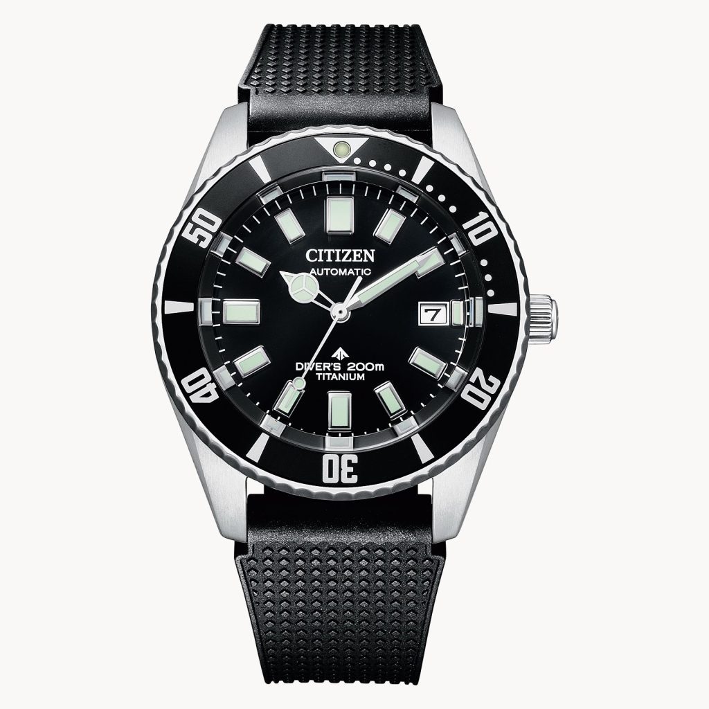 This photo shows the front face of the Citizen Promaster Dive Automatic watch. It has a black band with a black and silver case, and on the case it says "Citizen Automatic Diver's 200M Titanium".