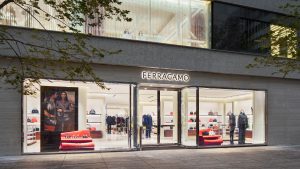 Photo of the new Ferragamo store front in Toronto. There is a big front window that shows the merchandise inside and a bright lit up sign above the door that says "Ferragamo".