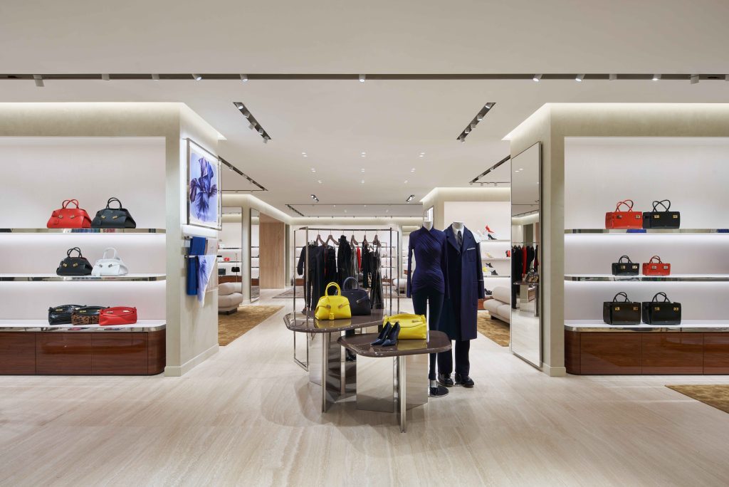Photo of the inside of the new Ferragamo store in Toronto. There is a big floor plan layout with bags on display as well as other clothing items.