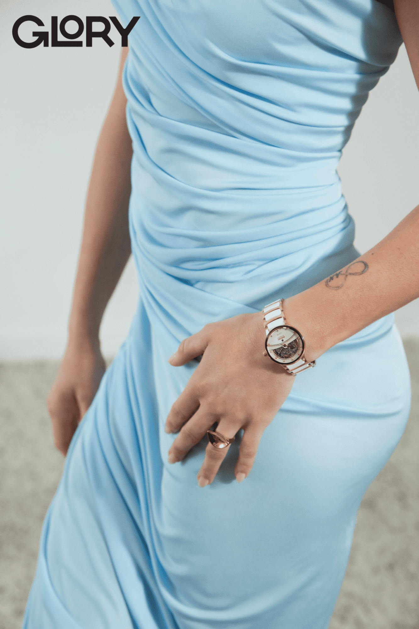 Light blue dress on a woman wearing a white Rado watch.