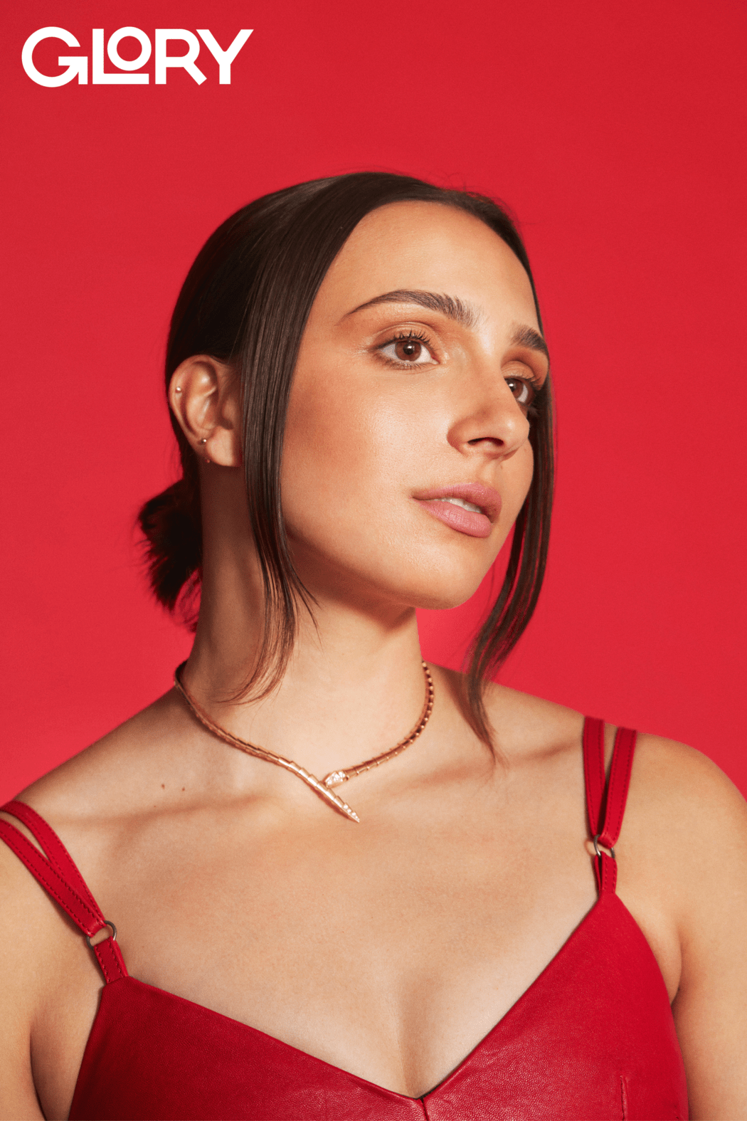 Marissa Papaconstantinou waering a red leather dress and a gold Bulgari necklace.